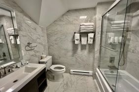 Spacious guest bathroom with shower at Skylaranna Hotel and Resort.