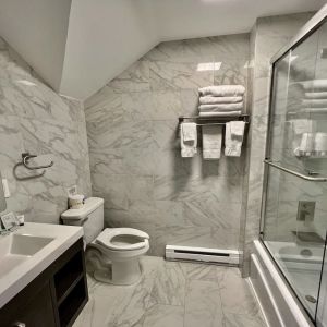 Spacious guest bathroom with shower at Skylaranna Hotel and Resort.