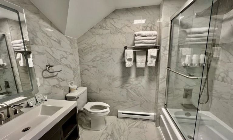 Spacious guest bathroom with shower at Skylaranna Hotel and Resort.