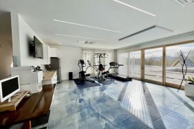 Fitness center with treadmill and weights at Skylaranna Hotel and Resort.