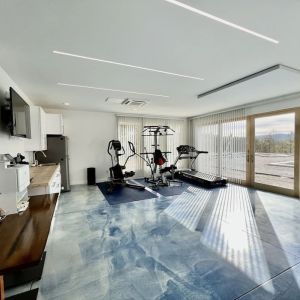 Fitness center with treadmill and weights at Skylaranna Hotel and Resort.