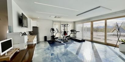 Fitness center with treadmill and weights at Skylaranna Hotel and Resort.