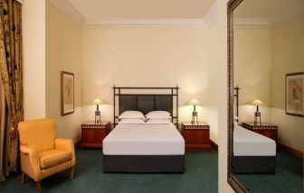 Spacious king bedroom with TV and work station at Grand Hyatt Muscat.