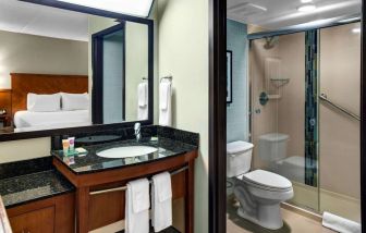 Private guest bathroom with shower at Hyatt Place Albuquerque Airport.