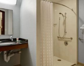 Private guest bathroom with shower at Hyatt Place Denver Airport.