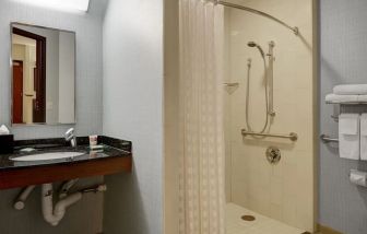 Private guest bathroom with shower at Hyatt Place Denver Airport.