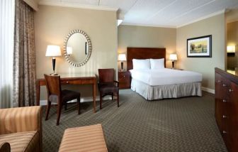 Delux king bed with TV and business desk at Hyatt Regency Houston West.