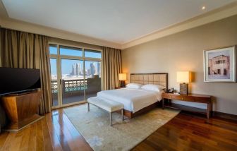 Spacious king bedroom with TV at Grand Hyatt Doha Hotel & Villas.