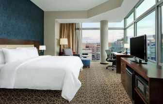 Delux king bed with TV and business desk at Hyatt Place DC Georgetown West End.