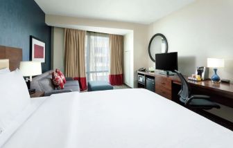 Spacious king bedroom with TV and work space at Hyatt Place DC Georgetown West End.