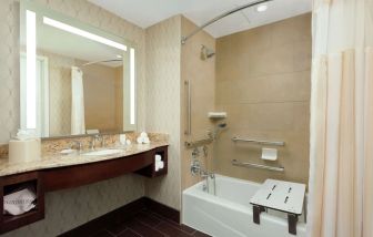 Private guest bathroom with shower at Hyatt Place DC Georgetown West End.