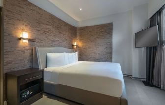 Spacious king bedroom with TV at Hyatt Herald Square New York.