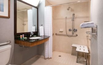 Private guest bathroom with shower at Hyatt Place New York Midtown South.