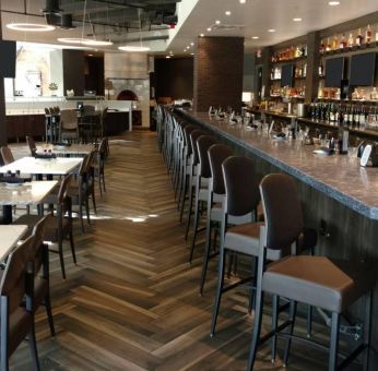 The Crowne Plaza Aire MSP Airport - Mall Of America’s restaurant and bar has table and bar stool seating.