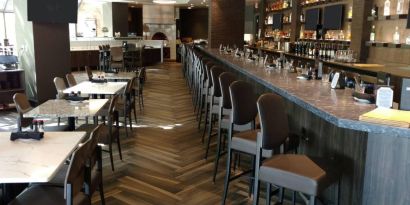 The Crowne Plaza Aire MSP Airport - Mall Of America’s restaurant and bar has table and bar stool seating.