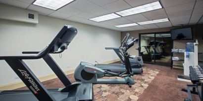 The hotel’s fitness center has racks of weights and numerous exercise machines.