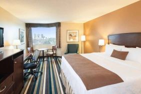 Best Western Plus Winnipeg Airport guest room, including large bed, and desk and chair for working.