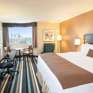 Best Western Plus Winnipeg Airport guest room, including large bed, and desk and chair for working.