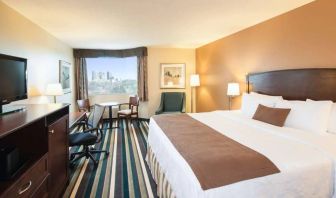 Best Western Plus Winnipeg Airport guest room, including large bed, and desk and chair for working.