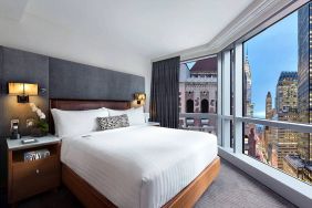 Hotel 48LEX New York guest room with double bed and stunning city view.