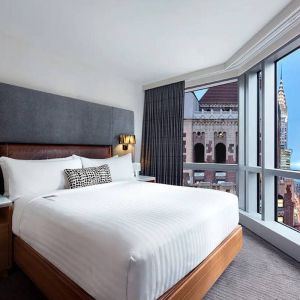 Hotel 48LEX New York guest room with double bed and stunning city view.