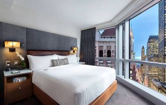 Hotel 48LEX New York guest room with double bed and stunning city view.