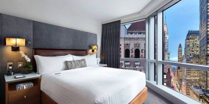 Hotel 48LEX New York guest room with double bed and stunning city view.