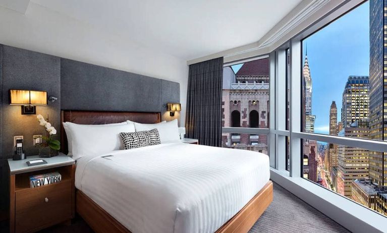 Hotel 48LEX New York guest room with double bed and stunning city view.