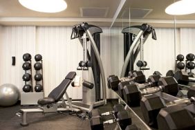 The Hotel 48LEX New York’s fitness center, with weights and exercise machinery.