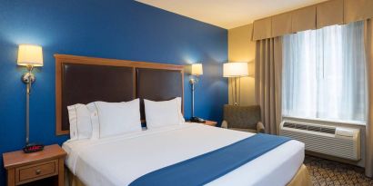 At guest room in the Holiday Inn Express New York City – Chelsea, with large bed and window.