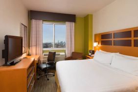 Guest room of the Holiday Inn Express Times Square, with double bed, window, TV, and desk.