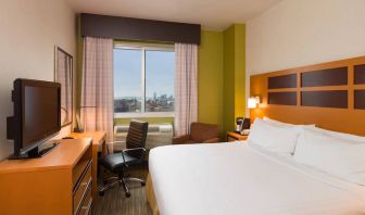 Guest room of the Holiday Inn Express Times Square, with double bed, window, TV, and desk.