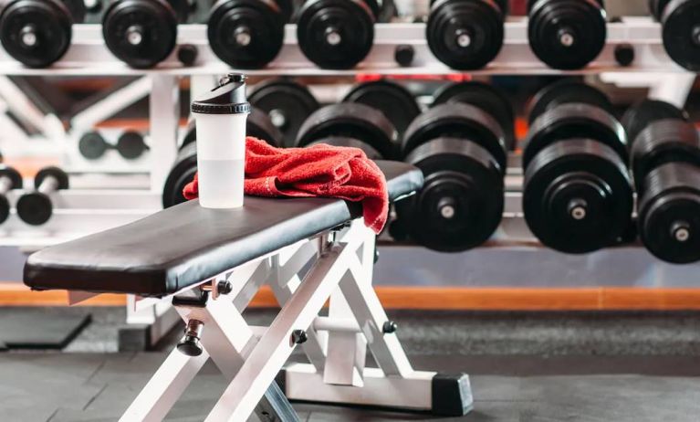 The hotel fitness center, with bench and wide selection of weights.