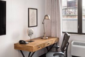 An in-room work station at the Hilton Garden Inn Tribeca, with lamp, chair, and desk.