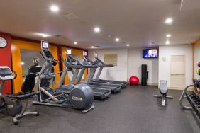 The hotel fitness center, which is equipped with weights, an exercise bench, and multiple machines.