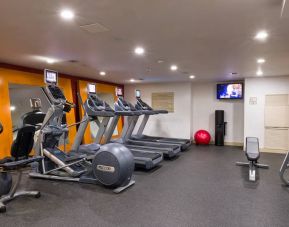 The hotel fitness center, which is equipped with weights, an exercise bench, and multiple machines.