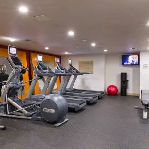 The hotel fitness center, which is equipped with weights, an exercise bench, and multiple machines.