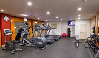 The hotel fitness center, which is equipped with weights, an exercise bench, and multiple machines.