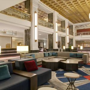 Lounge in the lobby of the New Yorker Hotel, A Wyndham Hotel, with stylish and comfortable sofa seating.