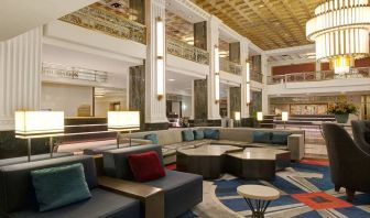 Lounge in the lobby of the New Yorker Hotel, A Wyndham Hotel, with stylish and comfortable sofa seating.