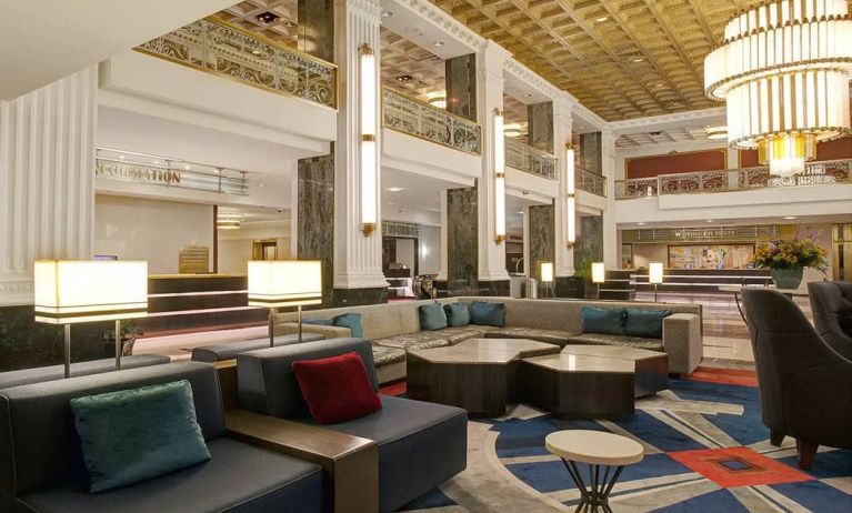 Lounge in the lobby of the New Yorker Hotel, A Wyndham Hotel, with stylish and comfortable sofa seating.