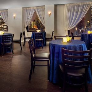 The hotel’s restaurant, with hard floor and tables for four.