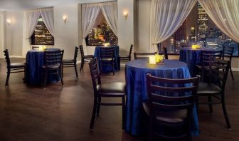 The hotel’s restaurant, with hard floor and tables for four.