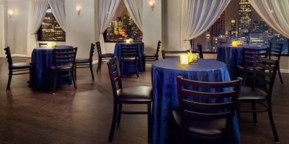 The hotel’s restaurant, with hard floor and tables for four.