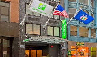 Exterior shot of the Holiday Inn Express Wall Street and its trio of fluttering flags.