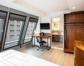 Guest room in La Quinta Times Square South, with workspace and ensuite bathroom.