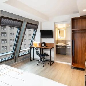 Guest room in La Quinta Times Square South, with workspace and ensuite bathroom.