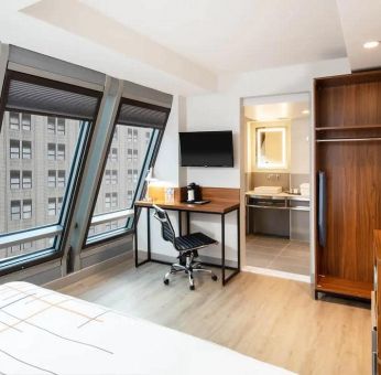 Guest room in La Quinta Times Square South, with workspace and ensuite bathroom.