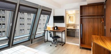 Guest room in La Quinta Times Square South, with workspace and ensuite bathroom.