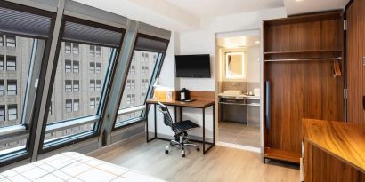 Guest room in La Quinta Times Square South, with workspace and ensuite bathroom.